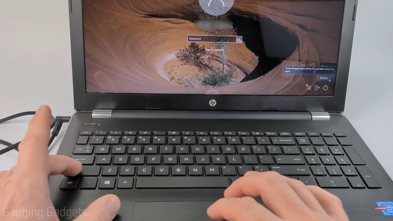 a man is pressing shift key in windows pc to enter in Windows Recovery Environment