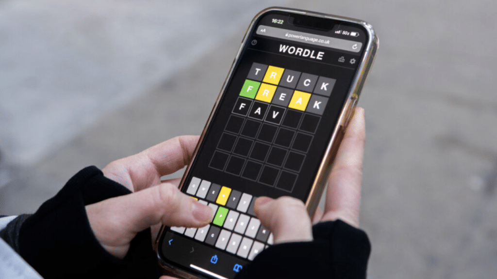 Image showing a man using Wordle Hint today to solve challenge